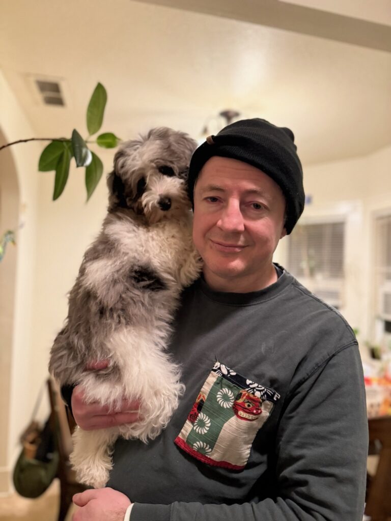 Holding Yuki, our three month old puppy. Don't hate dogs.